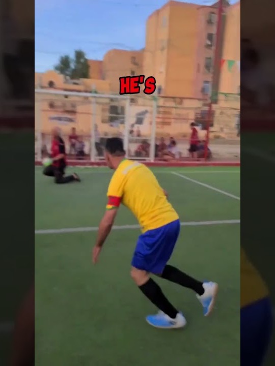 Choucha in a yellow and blue kit chasing the ball